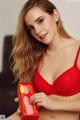 A woman in a red bra holding a red box.