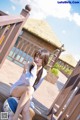 A woman sitting on a wooden deck with a volleyball.