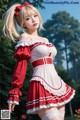 A woman in a red and white dress posing for a picture.