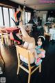 A woman sitting on a chair in a restaurant.