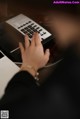 A person typing on a laptop computer at a desk.